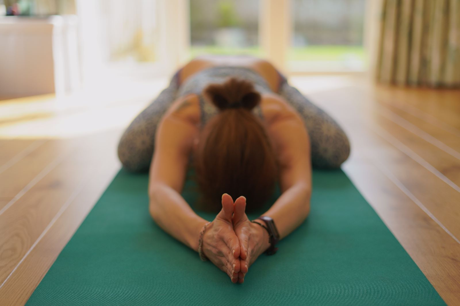 Christel Thimont in Extended Childs Pose (Utthita Balasana) which is a Vinyasa Yoga Pose.
